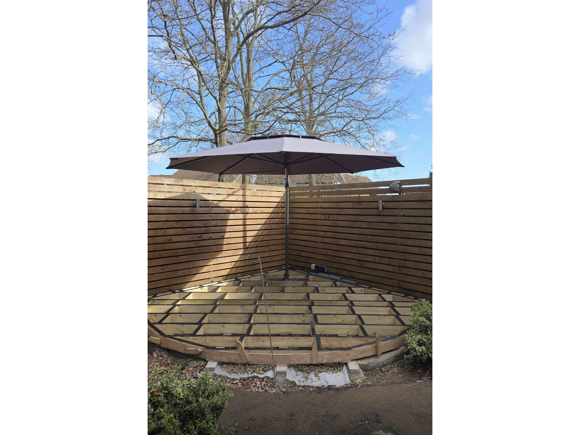 Complete garden landscaping with circular Millboard decking, curved paving and oak features