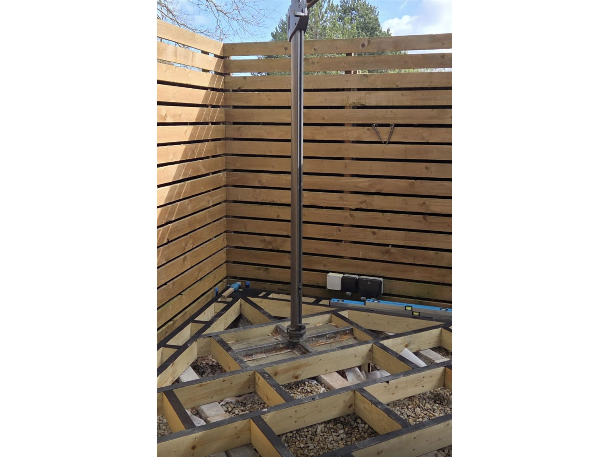 Bespoke curved garden transformation with circular decking and porcelain paving