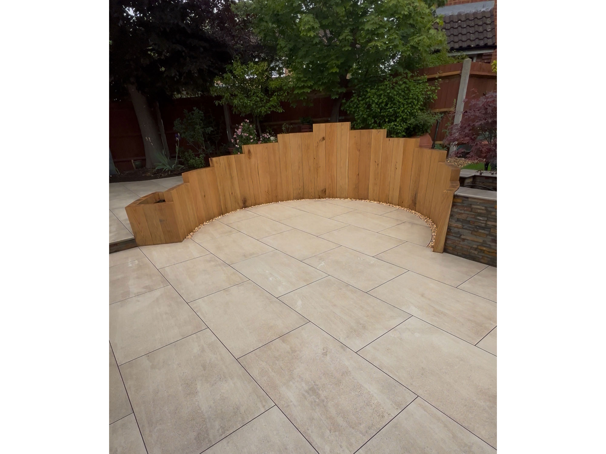 Garden makeover with contemporary porcelain paving, composite decking and bespoke oak features