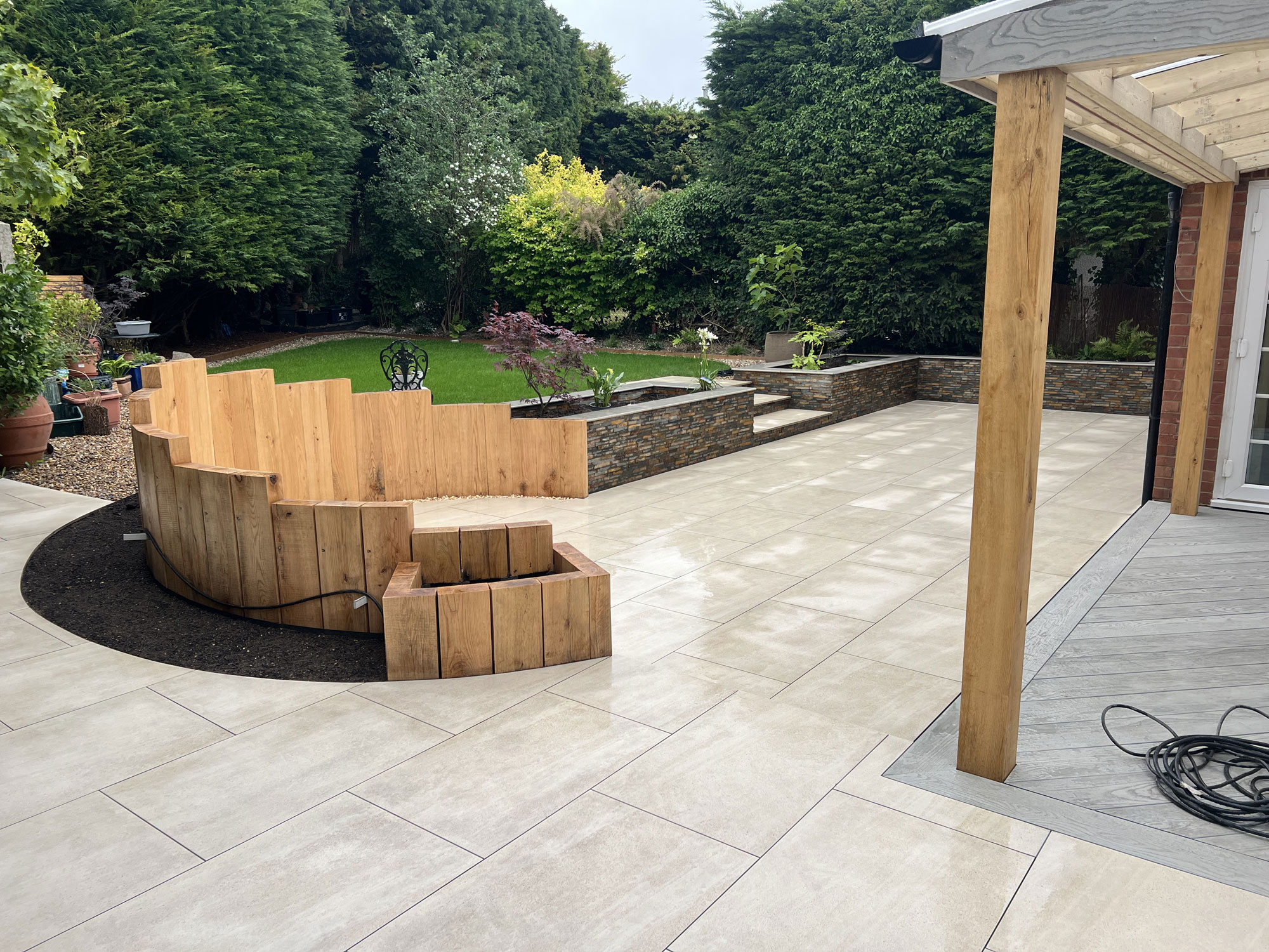 Complete garden landscaping project with oak garden features, Millboard decking and porcelain paving