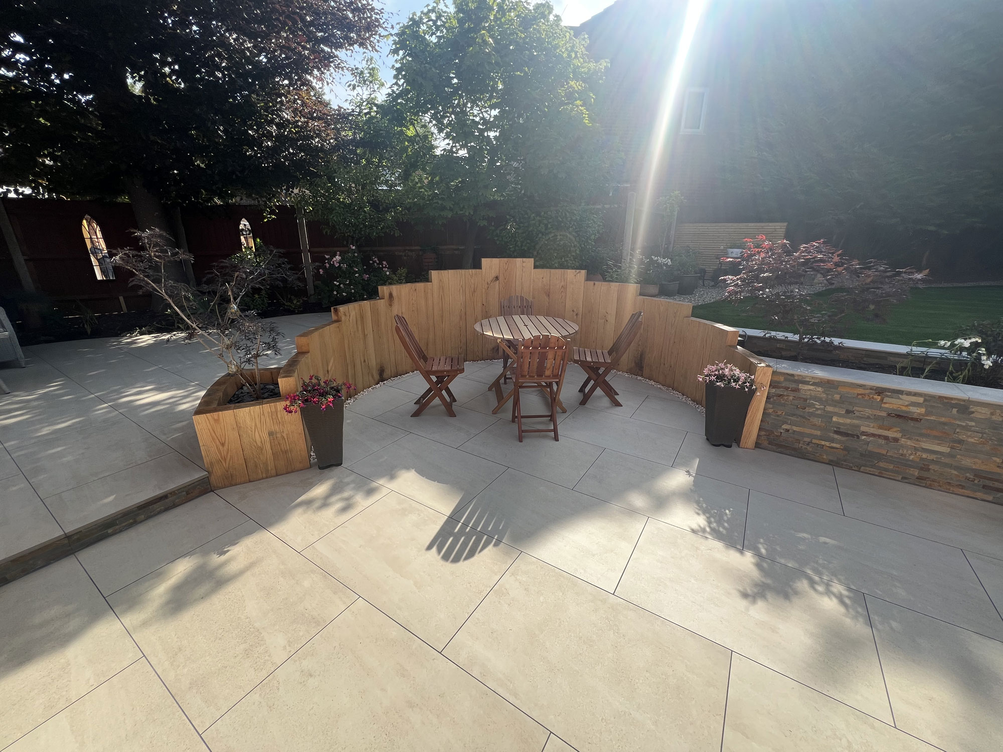 Contemporary garden landscaping project with porcelain paving, oak features and planting