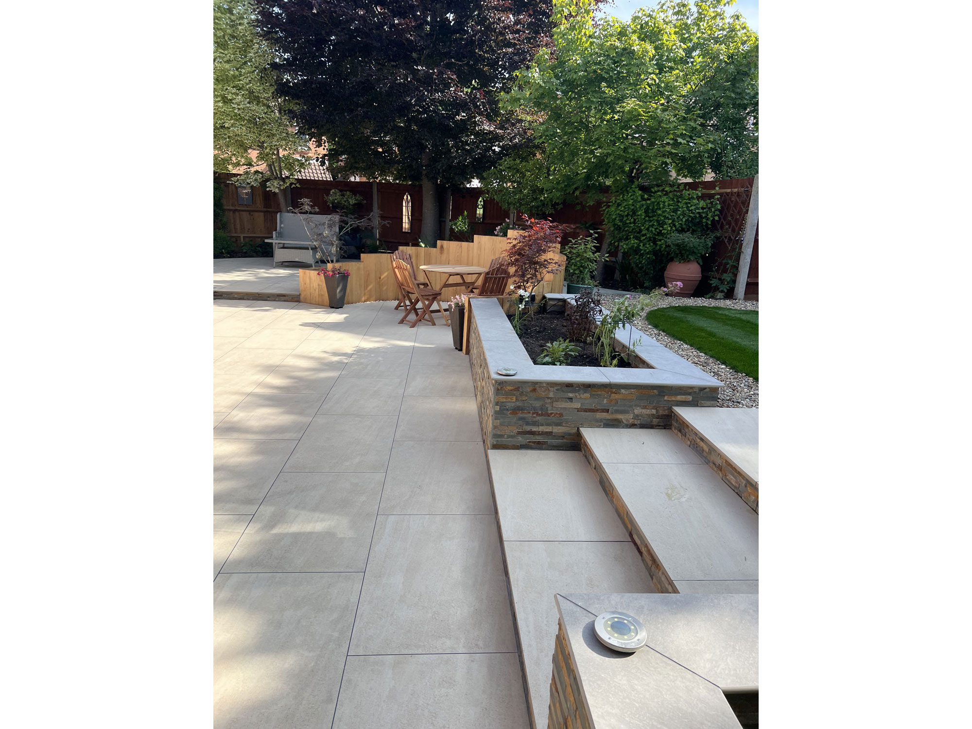 Garden transformation with premium porcelain paving and bespoke oak garden structures