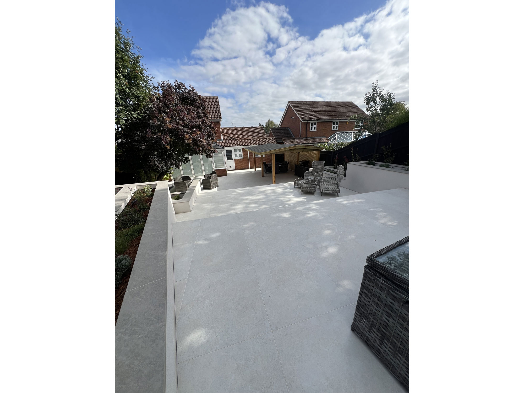 Rendered planters and raised beds adding structure to a modern porcelain paved garden
