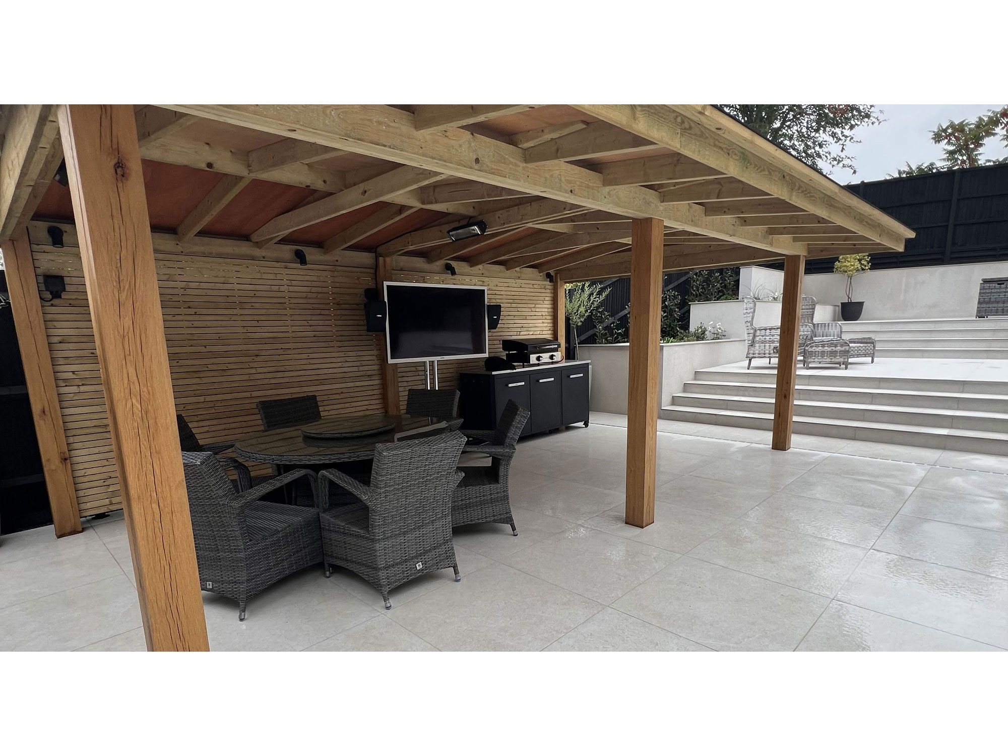 Contemporary garden with modern porcelain paving and rendered garden walls
