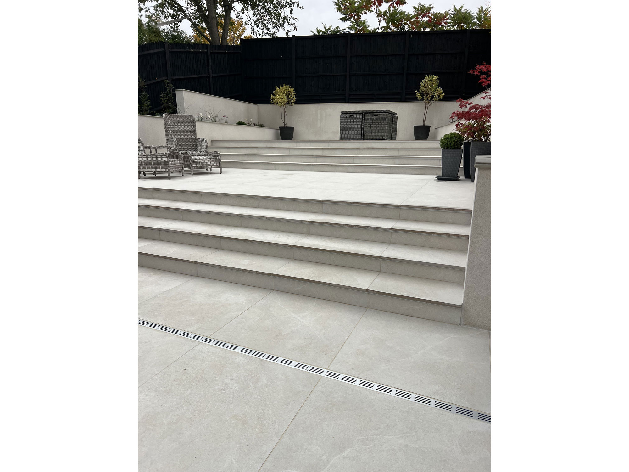Outdoor BBQ area with modern porcelain tiles and bespoke garden landscaping
